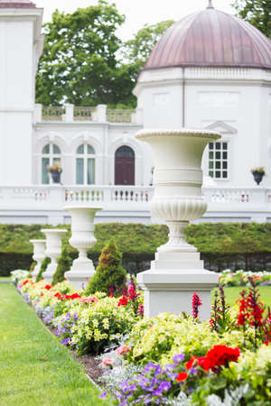 Four white antique vases in a resort park in summerの写真素材