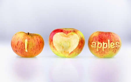 Three ecological apples with inscription I LOVE APPLES on a bright gradient backgroundの写真素材