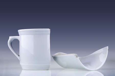 Broken white cup on a gradient background
