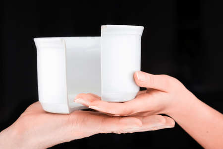 Caucasian couple   holding a broken mug  in a black background