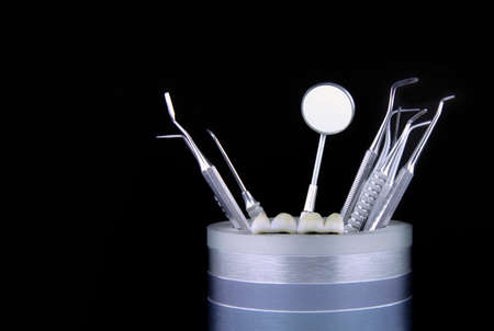 Dentist's tools and a denture on a black backgroundの写真素材