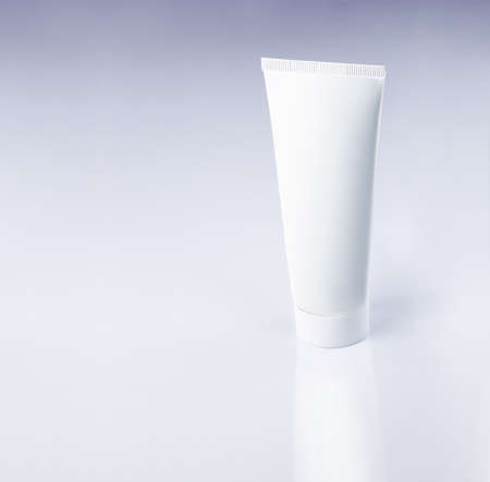 White plastic tube on a grey gradient backgroundの写真素材