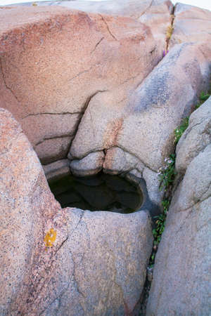 Dark hole in colorful rocks of Norway mountains for backgroundの写真素材