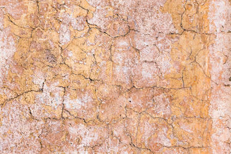 Background of old yellow brown white painted and cracked wallの写真素材