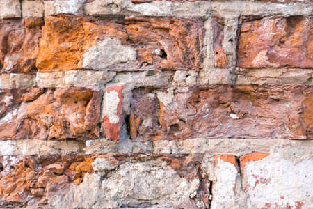 Close view of a colorful old red brick wallの写真素材