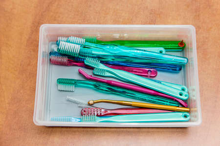 Various dental cleaning brushes in a plastic  box on a tableの写真素材