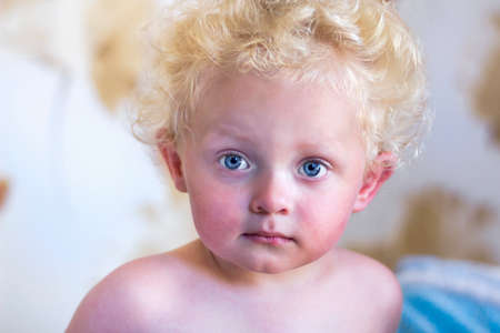 Portrait of a little boy with golden curly hairの写真素材