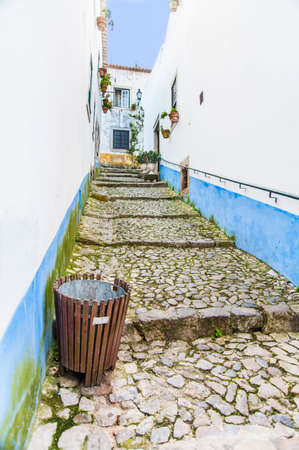 Wooden trash in old street of one of Portugal townsの写真素材