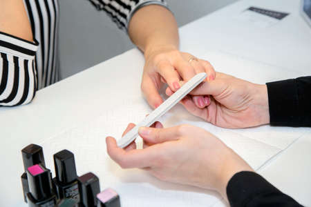 Manicurist doing manicure  in salon. Beauty concept.の写真素材
