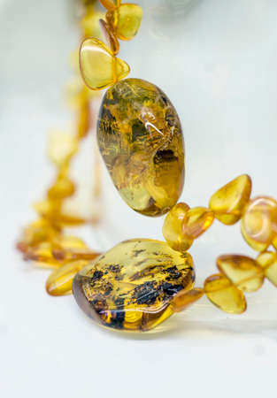 Close view of amber beads on a bright background backgroundの写真素材