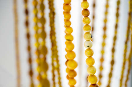 Close view of amber beads on a blurry backgroundの写真素材