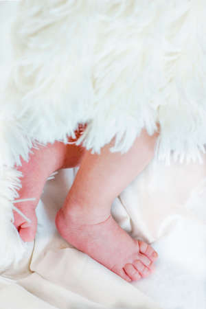 Close view of baby's feet in a blurred backgroundの写真素材