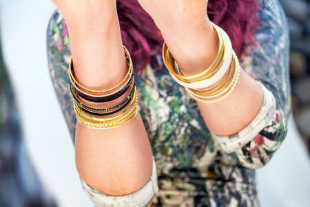 Close view of female's hands with golden braceletsの写真素材