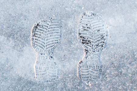 Human's foot print on a first snowの写真素材