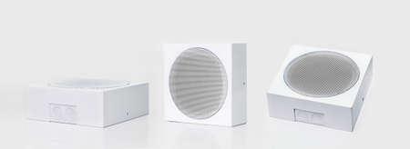 Three white loudspeakers on a white background