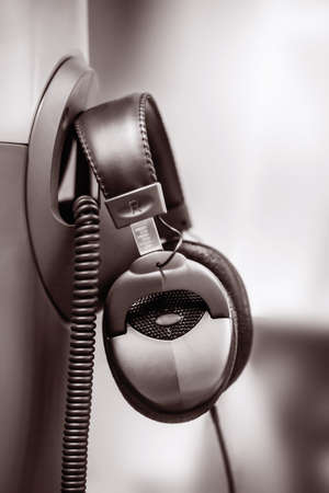 Close view of black stereo headphones in blurry background