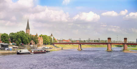 Bridge and ships on a river in old town in a cloudy dayの写真素材