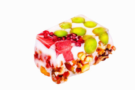 Piece of colorful milk jelly cake isolated on a white backgroundの写真素材