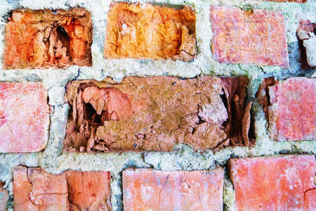 Old red brick wall with cracked bricks surface for background