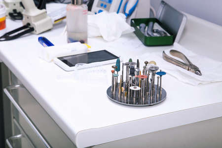 Close up photo of dental tools â drill burrs and denture polishers in a special holder on a dentist tableの写真素材