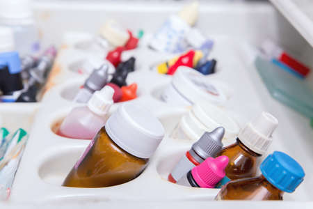 Close up photo of dentistâs tools drawer with various small bottlesの写真素材