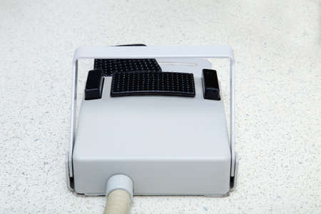 Dental chair foot controller on a floor in dental clinic