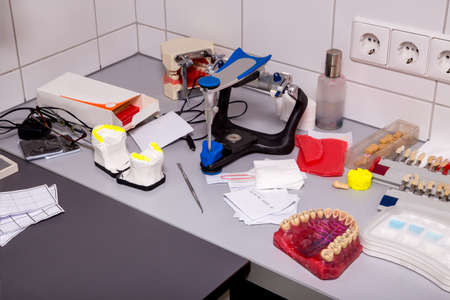 Dental prothetic laboratory. Dentist table with various things.の写真素材