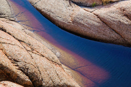 Close up of  red rock fragment with water