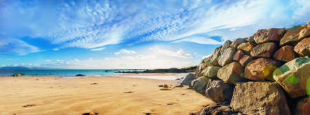 Panoramic landscape with big seashore stones and sand. ireland.の写真素材