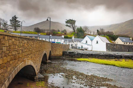 Stone bridge in a small Ireland town on cloudy spring dayの写真素材