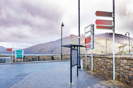 Road signs and billboard near Killary Harbor, a fjord located in the west of Ireland in the heart of Connemara which forms a natural border between counties Galway and Mayoの写真素材