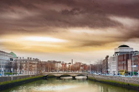 Cloudy on a river bridge in  a townの写真素材