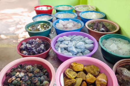 Various crude gems in a colorful baskets in a gemstone workshop in Sri Lankaの写真素材