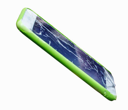 Close view green mobile phone whose screen is cracked isolated on whiteの写真素材