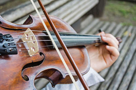 Close view of girls hands on a violin strings の写真素材