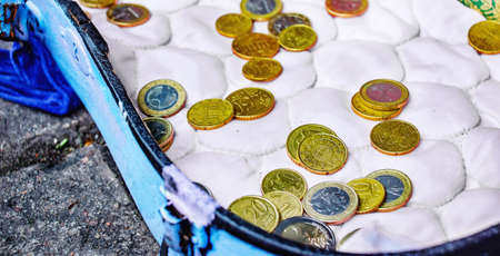 Close view of an old violin tray with donated euro coinsの写真素材