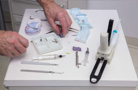 Dentist hands on a table with tools in a dental clinic