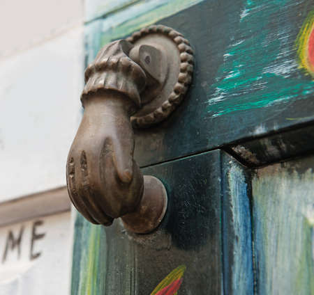 Ancient door knocker on wooden doorの写真素材