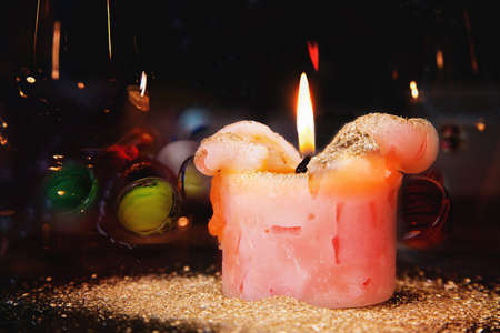 Romantic candle with golden dust on a festive tableの写真素材