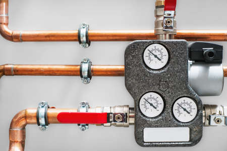 Boiler charging unit with copper pipes ant valves. Close up.の写真素材