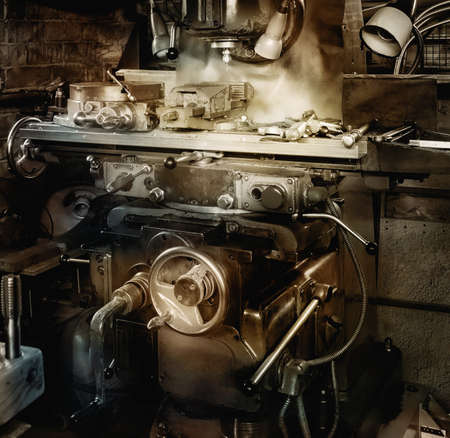 Old milling machine in a workshop. In vintage warm tones.