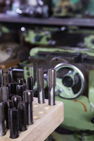 Various threads and tools for milling machine in a smith workshop. Close up.の写真素材