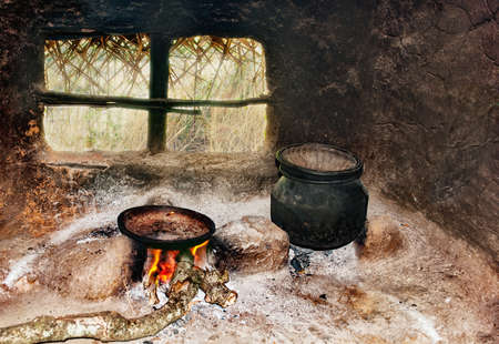 Sri Lanka's poor people's kitchen in the hut. A frying pan and a pot on a primitive cookerの写真素材
