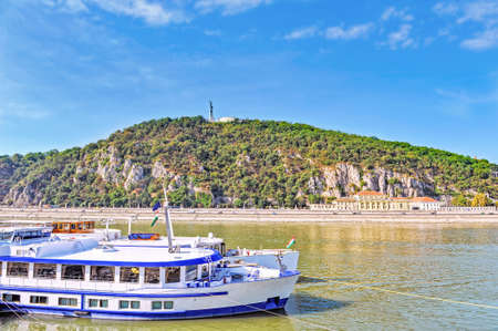 Gellert Hill with liberty monument in Budapest. View from Danube river side. Ships on a river.の写真素材