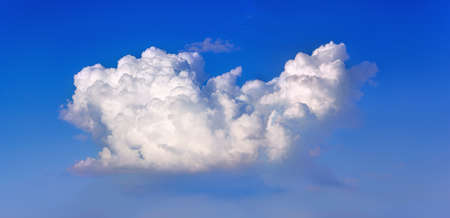 White cumulus cloud on a blue sky.