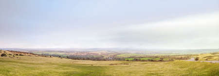 Panoramic southern England landscape with fog in the skyの写真素材