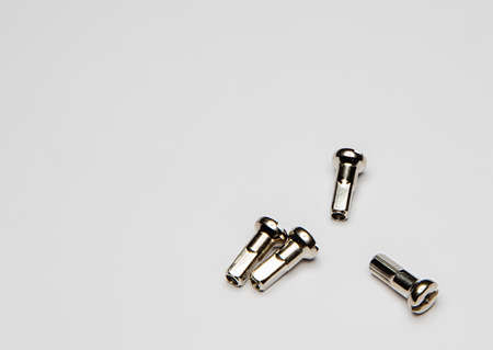 Four spoke nipples on a white background. Close up.の写真素材