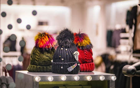 Three knitted hats on a self in a shop showcaseの写真素材