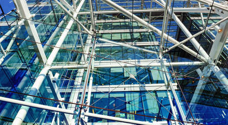 Metallic pipes and cords construction in a building with big windows