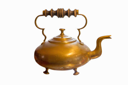 Ancient brass teapot with wooden handle isolated on whiteの写真素材